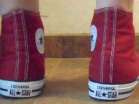 Chili Paste Red High Top Chucks  Wearing chili paste red high tops, rear view 1.